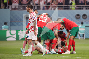 2022-12-17 - Achraf Dari of Morocco celebrates after scoring his team's first goal with team mates during the FIFA World Cup 2022, third place football match between Croatia and Morocco on December 17, 2022 at Khalifa International Stadium in Ar-Rayyan, Qatar - FOOTBALL - WORLD CUP 2022 - 3RD PLACE - CROATIA V MOROCCO - FIFA WORLD CUP - SOCCER
