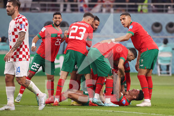 2022-12-17 - Achraf Dari of Morocco celebrates after scoring his team's first goal with team mates during the FIFA World Cup 2022, third place football match between Croatia and Morocco on December 17, 2022 at Khalifa International Stadium in Ar-Rayyan, Qatar - FOOTBALL - WORLD CUP 2022 - 3RD PLACE - CROATIA V MOROCCO - FIFA WORLD CUP - SOCCER