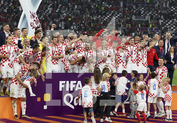2022-12-17 - Luka Modric of Croatia and teammates celebrate during the 3rd place medal ceremony following the FIFA World Cup 2022, third place football match between Croatia and Morocco on December 17, 2022 at Khalifa International Stadium in Al-Rayyan, Qatar - FOOTBALL - WORLD CUP 2022 - 3RD PLACE - CROATIA V MOROCCO - FIFA WORLD CUP - SOCCER