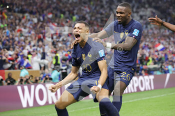 2022-12-18 - Kylian Mbappe of France celebrates his goal 2-2 with Marcus Thuram during the FIFA World Cup 2022, Final football match between Argentina and France on December 18, 2022 at Lusail Stadium in Al Daayen, Qatar - FOOTBALL - WORLD CUP 2022 - FINAL - ARGENTINA V FRANCE - FIFA WORLD CUP - SOCCER