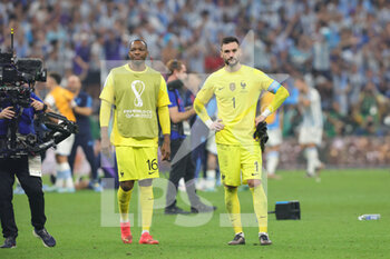 2022-12-18 - Hugo Lloris and Steve Mandanda of France look dejected after loosing the FIFA World Cup 2022, Final football match between Argentina and France on December 18, 2022 at Lusail Stadium in Al Daayen, Qatar - FOOTBALL - WORLD CUP 2022 - FINAL - ARGENTINA V FRANCE - FIFA WORLD CUP - SOCCER
