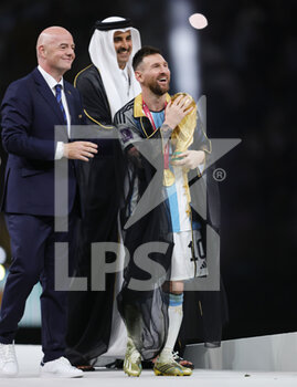 2022-12-18 - Lionel Messi of Argentina celebrates with the trophy with FIFA President Giovanni Infantino after the FIFA World Cup 2022, Final football match between Argentina and France on December 18, 2022 at Lusail Stadium in Al Daayen, Qatar - FOOTBALL - WORLD CUP 2022 - FINAL - ARGENTINA V FRANCE - FIFA WORLD CUP - SOCCER