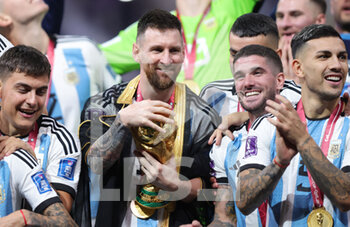 2022-12-18 - Lionel Messi of Argentina celebrates with the trophy after winning the FIFA World Cup 2022, Final football match between Argentina and France on December 18, 2022 at Lusail Stadium in Al Daayen, Qatar - FOOTBALL - WORLD CUP 2022 - FINAL - ARGENTINA V FRANCE - FIFA WORLD CUP - SOCCER