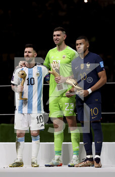 2022-12-18 - Lionel Messi for 'best player of the tournament', goalkeeper Emiliano Martinez of Argentina for 'best goalkeeper' and Kylian Mbappé of France for 'best scorer' with 8 goals during the trophy ceremony following the FIFA World Cup 2022, Final football match between Argentina and France on December 18, 2022 at Lusail Stadium in Al Daayen, Qatar - FOOTBALL - WORLD CUP 2022 - FINAL - ARGENTINA V FRANCE - FIFA WORLD CUP - SOCCER
