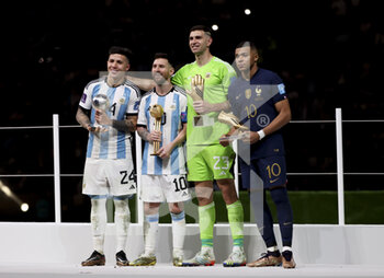2022-12-18 - Enzo Fernandez for 'best young player of the tournament', Lionel Messi for 'best player' , goalkeeper Emiliano Martinez of Argentina for 'best goalkeeper' and Kylian Mbappé of France for 'best scorer' with 8 goals during the trophy ceremony following the FIFA World Cup 2022, Final football match between Argentina and France on December 18, 2022 at Lusail Stadium in Al Daayen, Qatar - FOOTBALL - WORLD CUP 2022 - FINAL - ARGENTINA V FRANCE - FIFA WORLD CUP - SOCCER