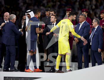 2022-12-18 - FIFA President Gianni Infantino, Emir of Qatar Sheikh Tamim bin Hamad Al Thani, President of France Emmanuel Macron, AFA President Claudio Tapia, FFF President Noel Le Graet give the medals to coach of France Didier Deschamps, Raphael Varane, France goalkeeper Hugo Lloris during the trophy ceremony following the FIFA World Cup 2022, Final football match between Argentina and France on December 18, 2022 at Lusail Stadium in Al Daayen, Qatar - FOOTBALL - WORLD CUP 2022 - FINAL - ARGENTINA V FRANCE - FIFA WORLD CUP - SOCCER