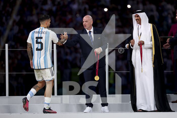 2022-12-18 - Leandro Paredes of Argentina, FIFA President Gianni Infantino, Emir of Qatar Sheikh Tamim bin Hamad Al Thani during the trophy ceremony following the FIFA World Cup 2022, Final football match between Argentina and France on December 18, 2022 at Lusail Stadium in Al Daayen, Qatar - FOOTBALL - WORLD CUP 2022 - FINAL - ARGENTINA V FRANCE - FIFA WORLD CUP - SOCCER