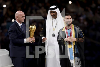 2022-12-18 - FIFA President Gianni Infantino, Emir of Qatar Sheikh Tamim bin Hamad Al Thani, Lionel Messi of Argentina during the trophy ceremony following the FIFA World Cup 2022, Final football match between Argentina and France on December 18, 2022 at Lusail Stadium in Al Daayen, Qatar - FOOTBALL - WORLD CUP 2022 - FINAL - ARGENTINA V FRANCE - FIFA WORLD CUP - SOCCER