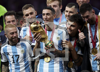 2022-12-18 - Angel Di Maria of Argentina holding the World Cup and teammates celebrate during the trophy ceremony following the FIFA World Cup 2022, Final football match between Argentina and France on December 18, 2022 at Lusail Stadium in Al Daayen, Qatar - FOOTBALL - WORLD CUP 2022 - FINAL - ARGENTINA V FRANCE - FIFA WORLD CUP - SOCCER