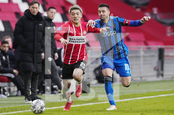 2022-01-23 - Ritsu Doan of PSV, Dusan Tadic of Ajax Amsterdam during the Netherlands championship Eredivisie football match between PSV Eindhoven and Ajax on January 23, 2022 at Philips Stadion in Eindhoven, Netherlands - PSV EINDHOVEN VS AJAX - NETHERLANDS EREDIVISIE - SOCCER