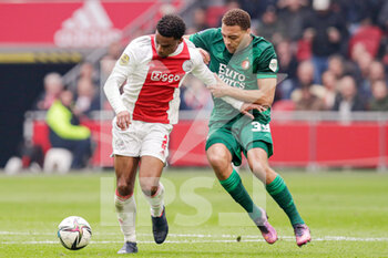2022-03-20 - Jurrien Timber of Ajax, Cyriel Dessers of Feyenoord during the Netherlands championship Eredivisie football match between AFC Ajax and Feyenoord on March 20, 2022 at Johan Cruijff Arena in Amsterdam, Netherlands - AFC AJAX VS FEYENOORD - NETHERLANDS EREDIVISIE - SOCCER