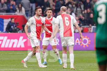 2022-03-20 - Dusan Tadic, Lisandro Martinez, Davy Klaassen of Ajax celebrate their teams second goal during the Netherlands championship Eredivisie football match between AFC Ajax and Feyenoord on March 20, 2022 at Johan Cruijff Arena in Amsterdam, Netherlands - AFC AJAX VS FEYENOORD - NETHERLANDS EREDIVISIE - SOCCER