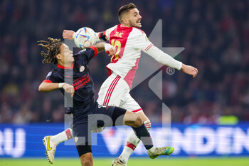 2022-11-06 - Xavi Simons of PSV battles for the ball with Dusan Tadic of Ajax during the Netherlands championship Eredivisie football match between Ajax and PSV on November 6, 2022 at the Johan Cruijff Arena in Amsterdam, Netherlands - FOOTBALL - NETHERLANDS CHAMP - AJAX V PSV - NETHERLANDS EREDIVISIE - SOCCER