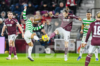 2022-01-26 - Rey Hatate (41) of Celtic FC and Peter Haring (5) of Heart of Midlothian FC during the Scottish championship, Cinch SPFL Premiership football match between Heart of Midlothian and Celtic on January 26, 2022 at Tynecastle Park in Edinburgh, Scotland - HEART OF MIDLOTHIAN VS CELTIC - SCOTTISH PREMIERSHIP - SOCCER