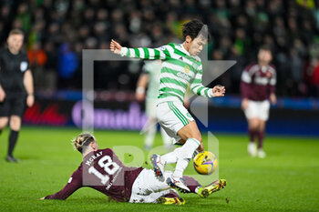 2022-01-26 - Barrie McKay (18) of Heart of Midlothian FC tackles Rey Hatate (41) of Celtic FC during the Scottish championship, Cinch SPFL Premiership football match between Heart of Midlothian and Celtic on January 26, 2022 at Tynecastle Park in Edinburgh, Scotland - HEART OF MIDLOTHIAN VS CELTIC - SCOTTISH PREMIERSHIP - SOCCER