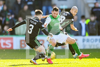 2022-02-27 - Hibs' Drey Wright holds off Celtic's Greg Taylor and Celtic's Daizen Maeda during the Scottish championship, Cinch Premiership football match between Hibernian and Celtic on February 27, 2022 at Easter Road Stadium in Edinburgh, Scotland - HIBERNIAN VSCELTIC - SCOTTISH PREMIERSHIP - SOCCER