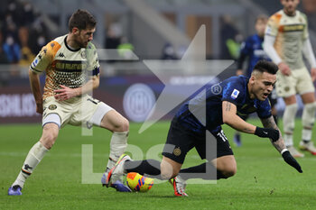 2022-01-22 - Lautaro Martinez of FC Internazionale fights for the ball against Marco Modolo of Venezia FC during the Serie A 2021/22 football match between FC Internazionale and Venezia FC at Giuseppe Meazza Stadium, Milan, Italy on January 22, 2022 - INTER - FC INTERNAZIONALE VS VENEZIA FC - ITALIAN SERIE A - SOCCER