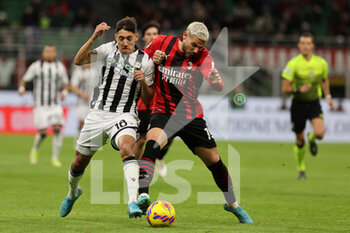 2022-02-25 - Theo Hernandez of AC Milan fights for the ball against Nahuel Molina of Udinese Calcio during the Serie A 2021/22 football match between AC Milan and Udinese Calcio at Giuseppe Meazza Stadium, Milan, Italy on February 25, 2022 - AC MILAN VS UDINESE CALCIO - ITALIAN SERIE A - SOCCER
