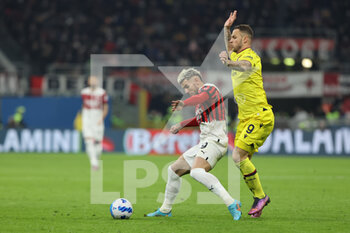 2022-04-04 - Theo Hernandez of AC Milan competes for the ball with Marko Arnautovic of Bologna FC during the Serie A 2021/22 football match between AC Milan and Bologna FC at Giuseppe Meazza Stadium, Milan, Italy on April 04, 2022 - AC MILAN VS BOLOGNA FC - ITALIAN SERIE A - SOCCER