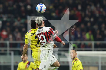 2022-04-04 - Theo Hernandez of AC Milan competes for the ball with Riccardo Orsolini of Bologna FC during the Serie A 2021/22 football match between AC Milan and Bologna FC at Giuseppe Meazza Stadium, Milan, Italy on April 04, 2022 - AC MILAN VS BOLOGNA FC - ITALIAN SERIE A - SOCCER