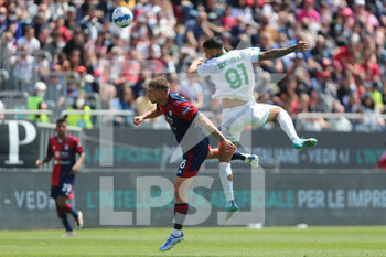 2022-04-16 - Matteo Lovato of CAGLIARI CALCIO competes for the ball with Gianluca Scamacca of US SASSUOLO during the Serie A match between Cagliari Calcio and US Sassuolo at Unipol Domus on April 16, 2022 in Cagliari, Italy. - CAGLIARI CALCIO VS US SASSUOLO - ITALIAN SERIE A - SOCCER