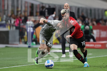 2022-04-15 - Theo Hernandez of AC Milan competes for the ball with Morten Frendrup of Genoa CFC during the Serie A 2021/22 football match between AC Milan and Genoa CFC at Giuseppe Meazza Stadium, Milan, Italy on April 15, 2022 - AC MILAN VS GENOA CFC - ITALIAN SERIE A - SOCCER