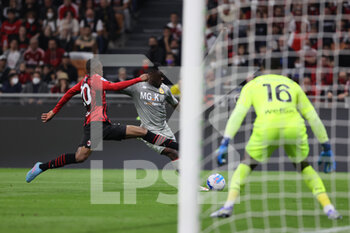 2022-04-15 - Caleb Ekuban of Genoa CFC and Pierre Kalulu of AC Milan in action during the Serie A 2021/22 football match between AC Milan and Genoa CFC at Giuseppe Meazza Stadium, Milan, Italy on April 15, 2022 - AC MILAN VS GENOA CFC - ITALIAN SERIE A - SOCCER