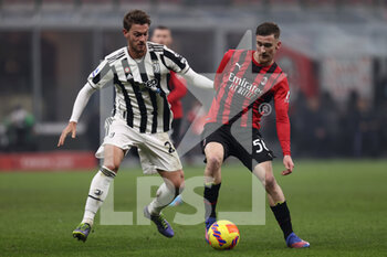 2022-01-23 - Alexis Saelemaekers (AC Milan) and Daniele Rugani (Juventus FC) battle for the ball  - AC MILAN VS JUVENTUS FC - ITALIAN SERIE A - SOCCER