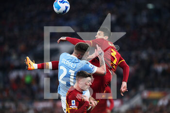 2022-03-20 - Roger Ibanez of Roma (R), Sergej Milinkovic Savic of Lazio (C) and Nicola Zalewski of Roma (DOWN) goes for a header during the Italian championship Serie A football match between AS Roma and SS Lazio on March 20, 2022 at Stadio Olimpico in Rome, Italy - AS ROMA VS SS LAZIO - ITALIAN SERIE A - SOCCER