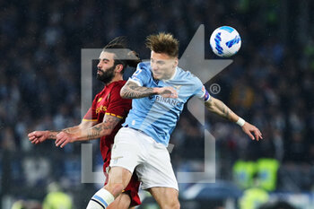 2022-03-20 - Sergio Oliveira of Roma (L) goes for a header with Ciro Immobile of Lazio (R) during the Italian championship Serie A football match between AS Roma and SS Lazio on March 20, 2022 at Stadio Olimpico in Rome, Italy - AS ROMA VS SS LAZIO - ITALIAN SERIE A - SOCCER