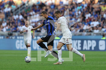 2022-09-10 - Edin Dzeko of FC Internazionale competes for the ball with Alessandro Buongiorno of Torino FC during the Serie A 2022/23 football match between FC Internazionale and Torino FC at Giuseppe Meazza Stadium, Milan, Italy on September 10, 2022 - INTER - FC INTERNAZIONALE VS TORINO FC - ITALIAN SERIE A - SOCCER
