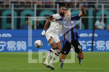 2022-09-10 - Edin Dzeko of FC Internazionale competes for the ball with Koffi Djidji of Torino FC during the Serie A 2022/23 football match between FC Internazionale and Torino FC at Giuseppe Meazza Stadium, Milan, Italy on September 10, 2022 - INTER - FC INTERNAZIONALE VS TORINO FC - ITALIAN SERIE A - SOCCER