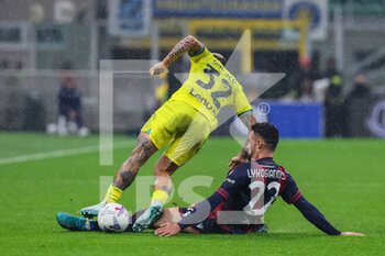 2022-11-09 - Federico Dimarco of FC Internazionale competes for the ball with Charalampos Lykogiannis of Bologna FC during Serie A 2022/23 football match between FC Internazionale and Bologna FC at Giuseppe Meazza Stadium, Milan, Italy on November 09, 2022 - INTER - FC INTERNAZIONALE VS BOLOGNA FC - ITALIAN SERIE A - SOCCER