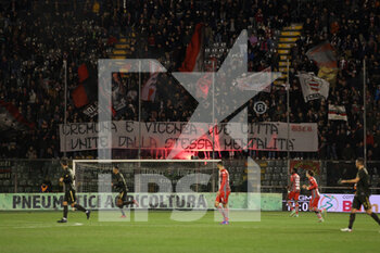 2022-02-22 - U.S. Cremonese fans light a torch and show a banner - US CREMONESE VS LR VICENZA - ITALIAN SERIE B - SOCCER