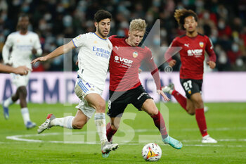 2022-01-08 - Marco Asensio of Real Madrid and Daniel Wass of Valencia during the Spanish championship La liga football match between Real Madrid and Valencia CF on January 8, 2022 at Santiago Bernabeu stadium in Madrid, Spain - REAL MADRID VS VALENCIA CF - SPANISH LA LIGA - SOCCER