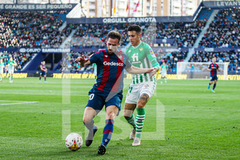 2022-02-13 - Jorge Miramon of Levante UD and Cristian Tello of Real Betis during the Spanish championship La Liga football match between Levante UD and Real Betis Balompie on February 13, 2022 at the Ciutat de Valencia Stadium in Valencia, Spain - LEVANTE UD VS REAL BETIS BALOMPIE - SPANISH LA LIGA - SOCCER