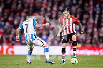 2022-02-20 - Yuri Berchiche of Athletic Club competes for the ball with Cristian Portu of Real Sociedad during the Spanish championship La Liga football match between Athletic Club and Real Sociedad on February 20, 2022 at San Mames stadium in Bilbao, Spain - ATHLETIC CLUB VS REAL SOCIEDAD - SPANISH LA LIGA - SOCCER
