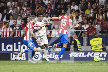 2022-05-08 - 30.04.2022, Madrid, Spain. Vinicius Junior of Real Madrid CF (C) battles for the ball with Sime Vrsaljko of Atletico de Madrid (L) and Stefan Savic of Atletico de Madrid (R) during the LaLiga Santander match between Atletico de Madrid and Real Madrid at Wanda Metropolitano on 8 May 2022 in Madrid, Spain. - ATLETICO DE MADRID VS REAL MADRID - SPANISH LA LIGA - SOCCER