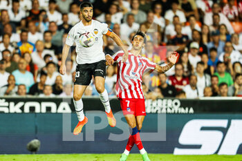 2022-08-29 - Carlos Soler of Valencia and Joao Felix of Atletico de Madrid during the Spanish championship La Liga football match between Valencia CF and Atletico de Madrid on August 29, 2022 at the Mestalla Stadium in Valencia, Spain - FOOTBALL - SPANISH CHAMP - VALENCIA V ATLETICO MADRID - SPANISH LA LIGA - SOCCER