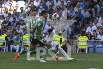2022-09-03 - 03.09.2022, Madrid, Spain. Vinicius Junior of Real Madrid CF (R) battles for the ball with Guido Rodriguez of Real Betis (L) during the LaLiga Santander match between Real Madrid CF and Real Betis at Santiago Bernabeu on 3 September 2022 in Madrid, Spain. - LALIGA SANTANDER 2021/2023- REAL MADRID VS REAL BETIS - SPANISH LA LIGA - SOCCER