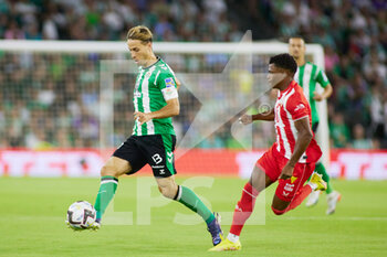 2022-10-16 - Sergio Canales of Real Betis and Lathie Ramazani of UD Almeria during the Spanish championship La Liga football match between Real Betis and UD Almeria on October 16, 2022 at Benito Villamarin stadium in Sevilla, Spain - FOOTBALL - SPANISH CHAMP - REAL BETIS V ALMERIA - SPANISH LA LIGA - SOCCER