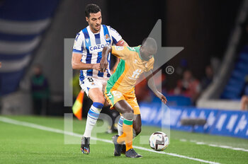 2022-10-30 - Youssouf Sabaly of Real Betis Balompie competes for the ball with Mikel Merino of Real Sociedad during the Spanish championship La Liga football match between Real Sociedad and Real Betis Balompie on October 30, 2022 at Reale Arena in San Sebastian, Spain - FOOTBALL - SPANISH CHAMP - REAL SOCIEDAD V REAL BETIS - SPANISH LA LIGA - SOCCER