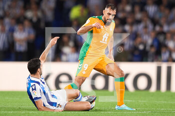 2022-10-30 - Borja Iglesias of Real Betis Balompie competes for the ball with Mikel Merino of Real Sociedad during the Spanish championship La Liga football match between Real Sociedad and Real Betis Balompie on October 30, 2022 at Reale Arena in San Sebastian, Spain - FOOTBALL - SPANISH CHAMP - REAL SOCIEDAD V REAL BETIS - SPANISH LA LIGA - SOCCER