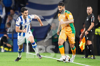 2022-10-30 - Sergio Canales of Real Betis Balompie competes for the ball with Mikel Merino of Real Sociedad during the Spanish championship La Liga football match between Real Sociedad and Real Betis Balompie on October 30, 2022 at Reale Arena in San Sebastian, Spain - FOOTBALL - SPANISH CHAMP - REAL SOCIEDAD V REAL BETIS - SPANISH LA LIGA - SOCCER