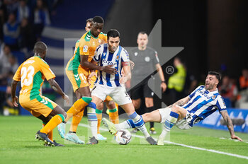 2022-10-30 - Mikel Merino of Real Sociedad competes for the ball with Youssouf Sabaly of Real Betis Balompie during the Spanish championship La Liga football match between Real Sociedad and Real Betis Balompie on October 30, 2022 at Reale Arena in San Sebastian, Spain - FOOTBALL - SPANISH CHAMP - REAL SOCIEDAD V REAL BETIS - SPANISH LA LIGA - SOCCER