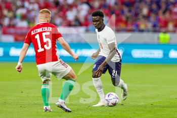 2022-06-04 - Bukayo Saka (21) of England takes on Laszlo Kleinheisler (15) of Hungary during the UEFA Nations League, League A - Group 3 football match between Hungary and England on June 4, 2022 at Puskas Arena Park in Budapest, Hungary - FOOTBALL - NATIONS LEAGUE 2022 - HUNGARY V ENGLAND - UEFA NATIONS LEAGUE - SOCCER