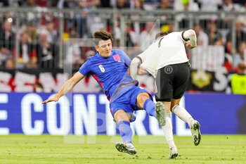 2022-06-07 - Harry Maguire (6) of England is knocked over by Kai Havertz (7) of Germany during the UEFA Nations League 2022, League A - Group 3 football match between Germany and England on June 7, 2022 at Allianz Arena in Munich, Germany - FOOTBALL - NATIONS LEAGUE 2022 - GERMANY V ENGLAND - UEFA NATIONS LEAGUE - SOCCER