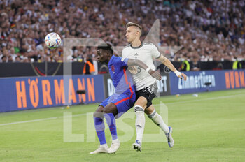 2022-06-07 - Bukayo Saka of England and Nico Schlotterbeck of Germany during the UEFA Nations League 2022, League A - Group 3 football match between Germany and England on June 7, 2022 at Allianz Arena in Munich, Germany - FOOTBALL - NATIONS LEAGUE 2022 - GERMANY V ENGLAND - UEFA NATIONS LEAGUE - SOCCER