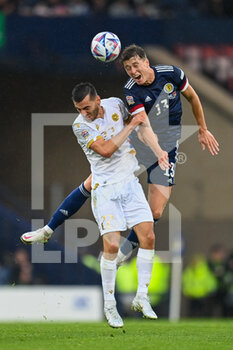 2022-06-08 - Scotland's Jack Hendry wins a header against Armenia's Sargis Adamyan during the UEFA Nations League 2022, League B - Group 1 football match between Scotland and Armenia on June 8, 2022 at Hampden Park in Glasgow, Scotland - FOOTBALL - NATIONS LEAGUE 2022 - SCOTLAND V ARMENIA - UEFA NATIONS LEAGUE - SOCCER