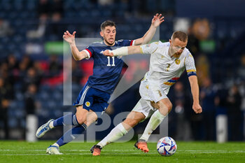 2022-06-08 - Armenia's Varazdat Haroyan holds off Scotland's Ryan Christie during the UEFA Nations League 2022, League B - Group 1 football match between Scotland and Armenia on June 8, 2022 at Hampden Park in Glasgow, Scotland - FOOTBALL - NATIONS LEAGUE 2022 - SCOTLAND V ARMENIA - UEFA NATIONS LEAGUE - SOCCER